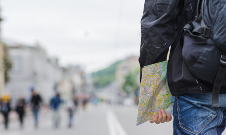 crop man with map city street