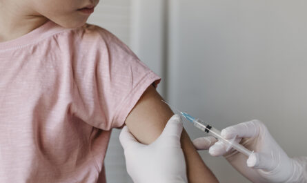 doctor administering vaccine kid