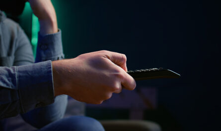 close up man couch using remote control
