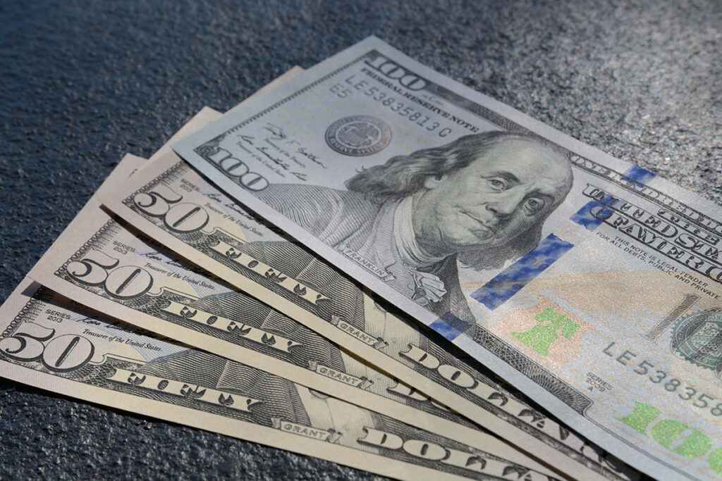 closeup shot three fifty one hundred dollars bills