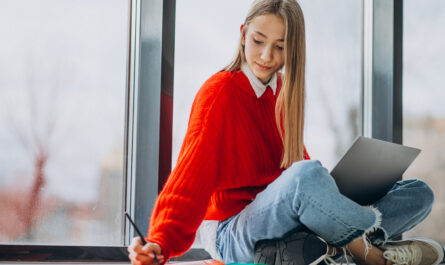 girl student studying computer by window 1