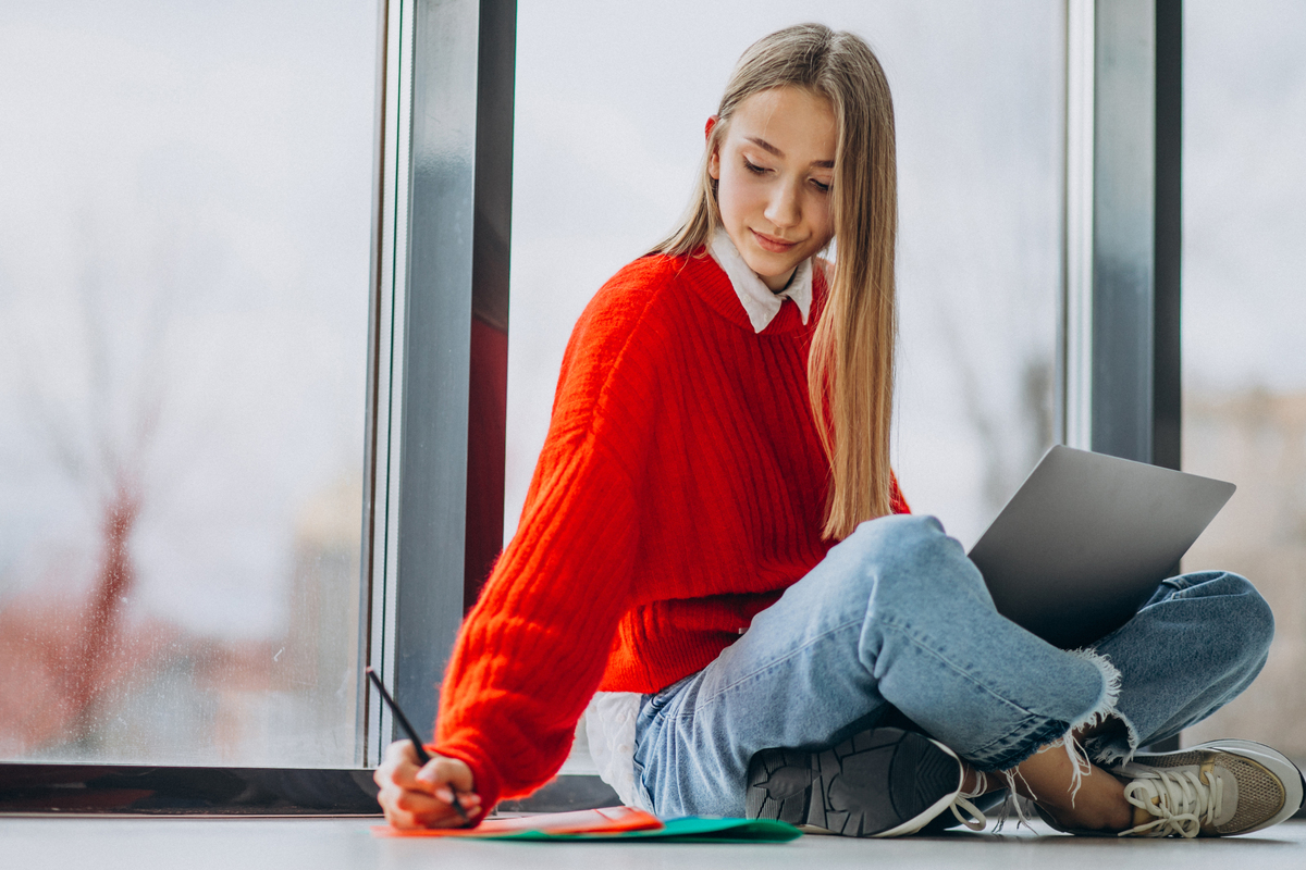 girl student studying computer by window 1