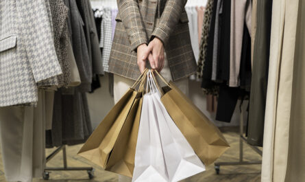 close up hands holding shopping bags