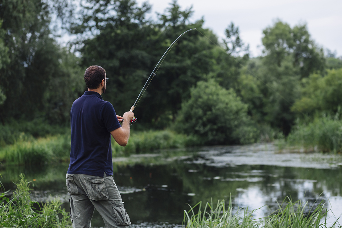 close up man fishing lake