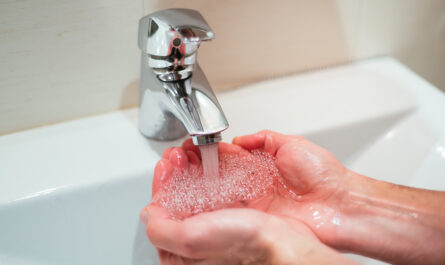 closeup shot person washing hands sink