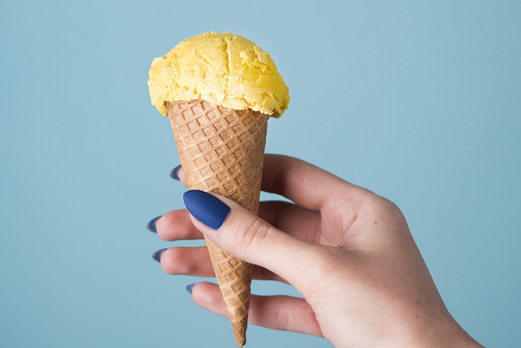 hand holding delicious ice cream cone