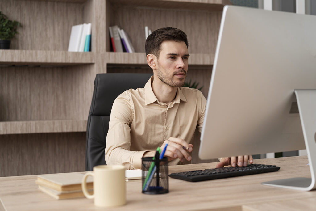 medium shot focused man working computer