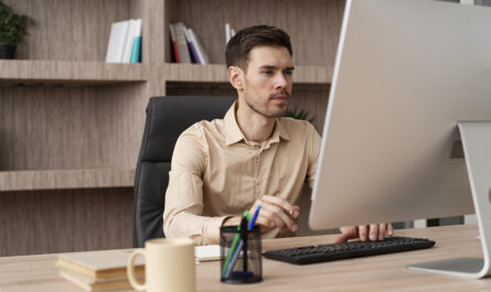 medium shot focused man working computer