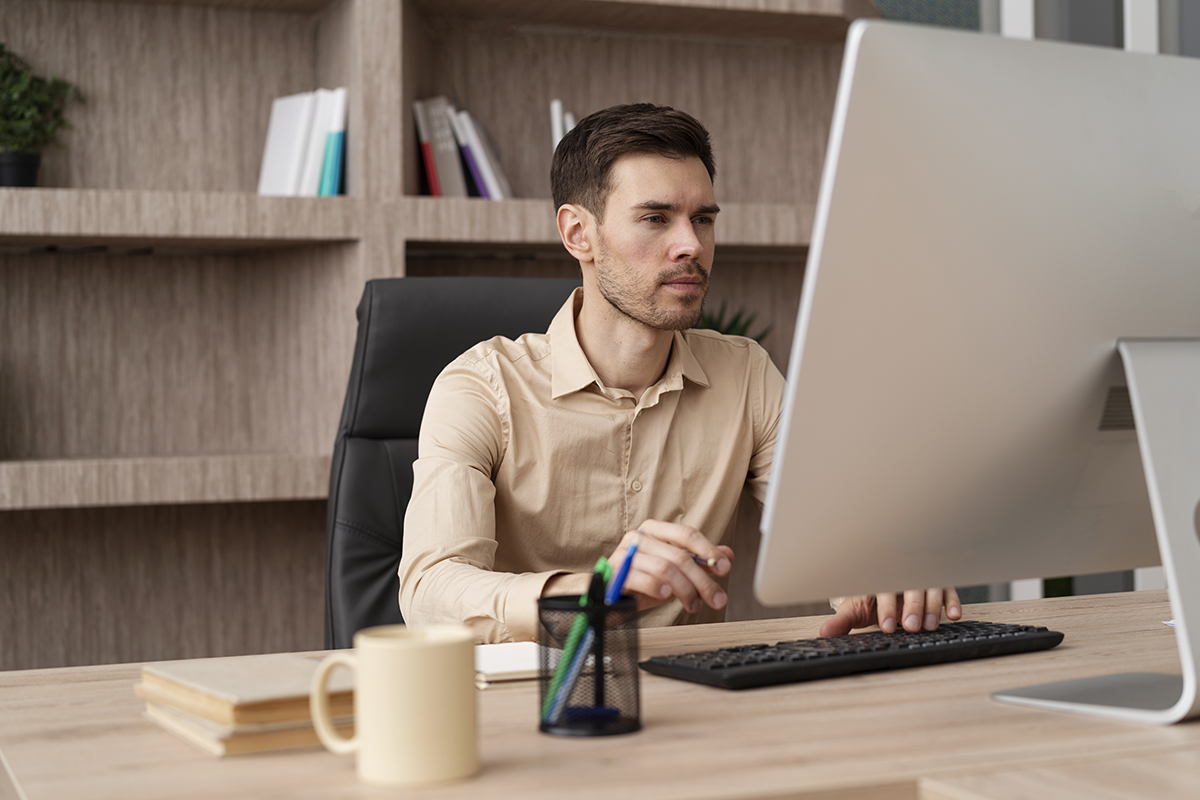 medium shot focused man working computer