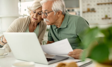 senior couple analyzing their savings while going through home finances