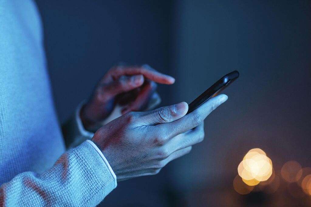 side view man using smartphone
