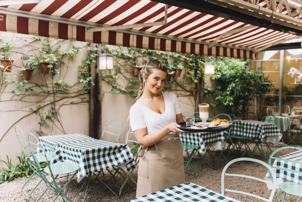 smiling waitress holding tray 1