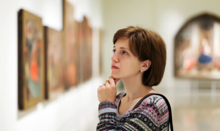 visitor looking pictures art gallery