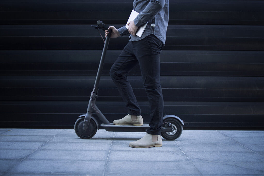business person with tablet computer his electric scooter commuting vehicle