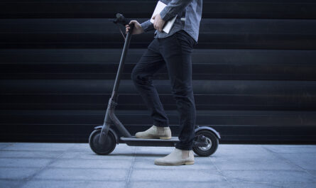 business person with tablet computer his electric scooter commuting vehicle