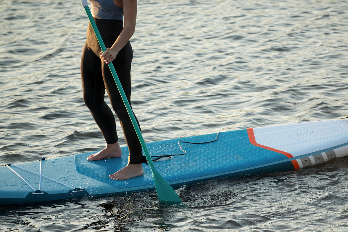 close up woman paddleboarding