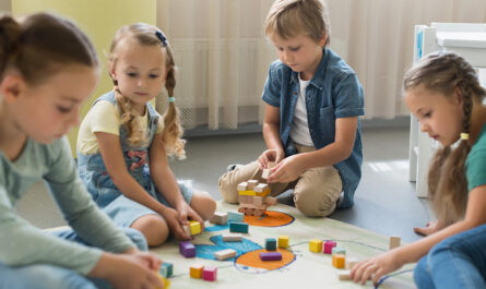 front view children playing together kindergarten
