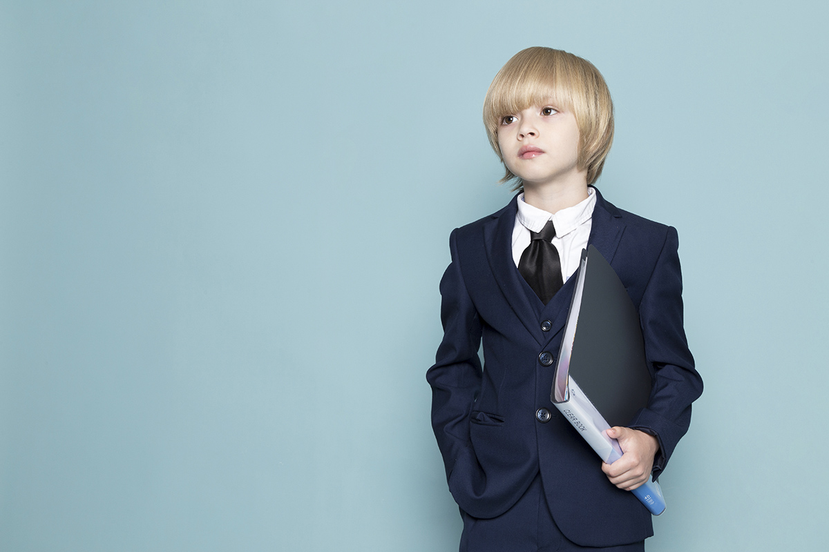 front view cute business boy blue classic suit holding black folder business work fashion