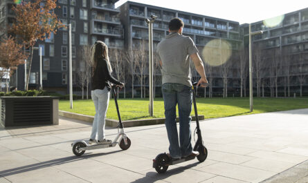full shot people traveling with electric scooters