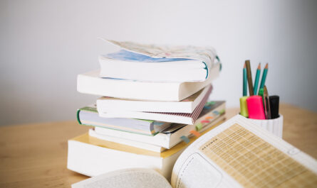 stack notebooks cup with pencils
