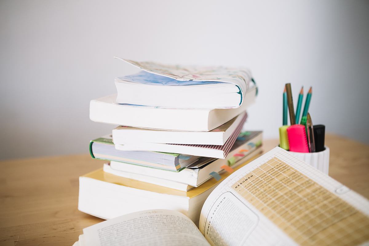 stack notebooks cup with pencils