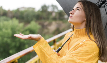 woman feeling rain with her hand