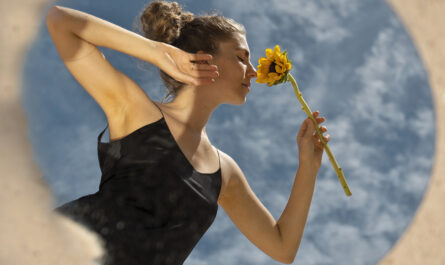 woman posing with round mirror flower