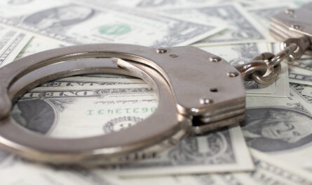 closeup view metal handcuffs dollars