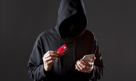 front view male hacker holding smartphone credit card