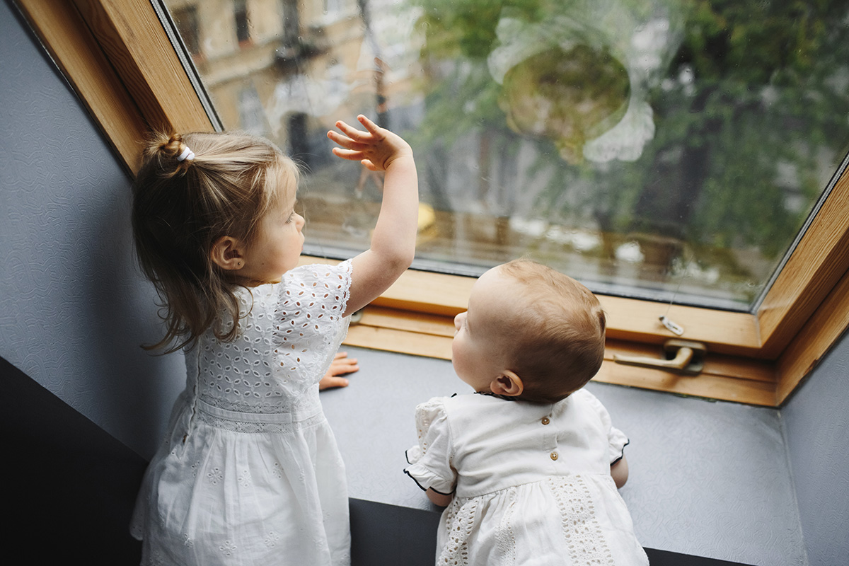 little children look out window