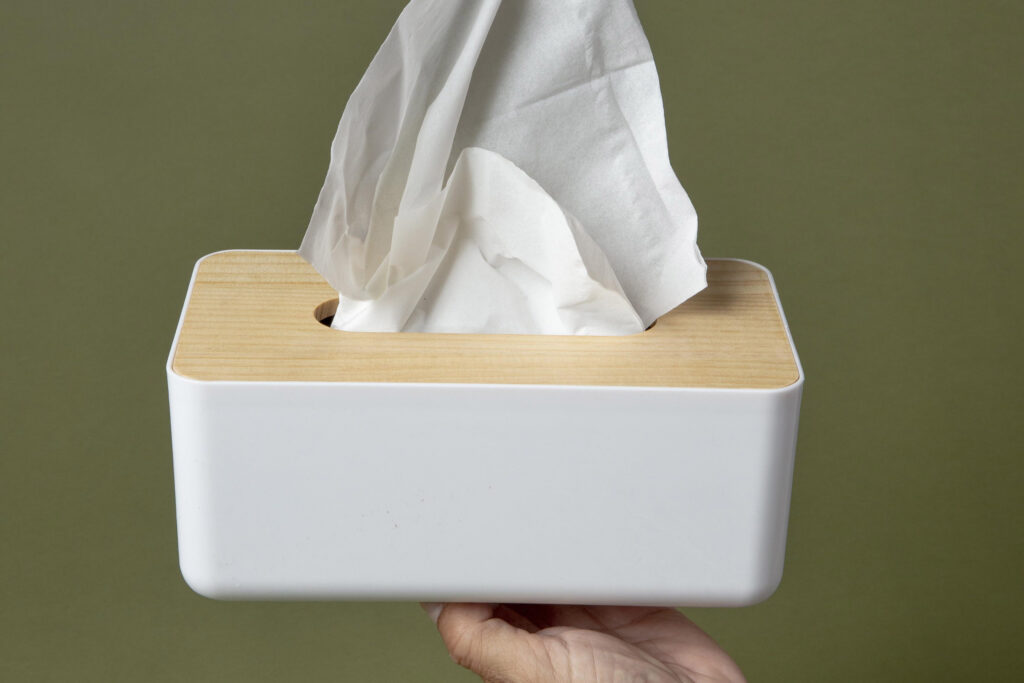 person holding white nasal handkerchief