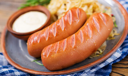 plate sausages sauerkraut wooden table traditional oktoberfest menu
