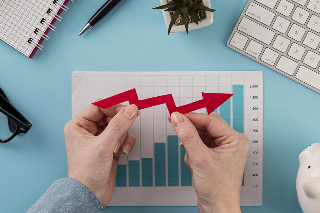 top view business items with growth chart hands holding arrow