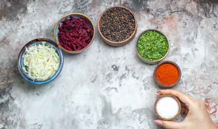 top view different seasonings with sliced cabbage greens beet white background