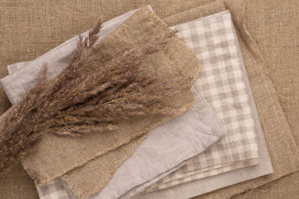 flat lay monochromatic selection textiles with dried grass