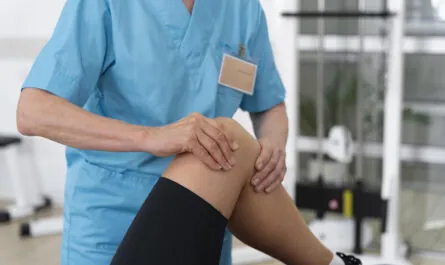 medical assistant helping patient with physiotherapy exercises