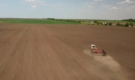 farmer tractor preparing land with seedbed cultivator as part pre seeding activities early spring season agricultural works farmlands drone photo
