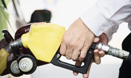 man putting gasoline fuel into his car pump gas station