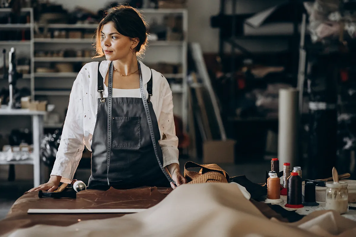 woman tailor working leather fabric