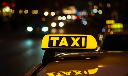 yellow black sign taxi placed top car night