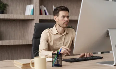 medium shot focused man working computer