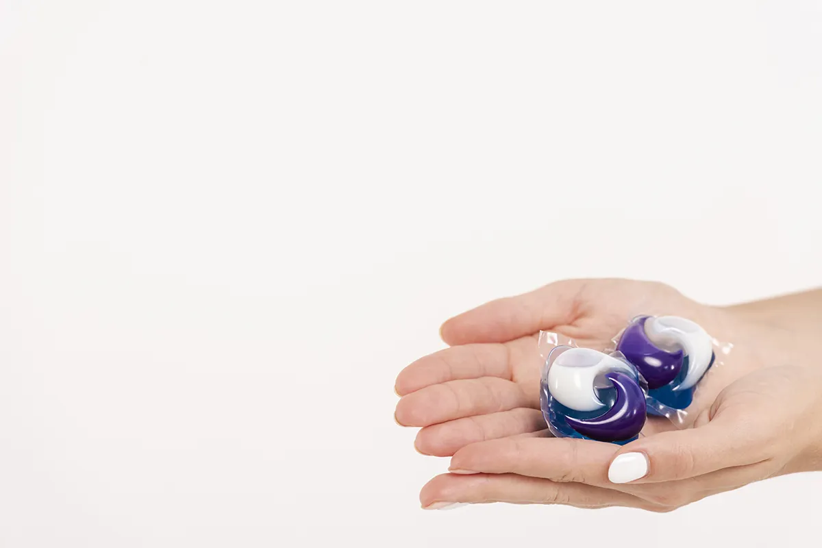 close up woman holding washing tablets
