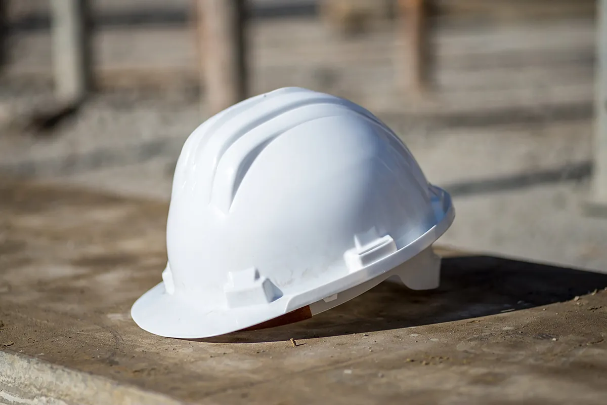 white construction helmet ground sunlight
